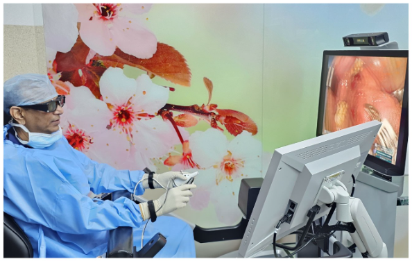 PROF DR SANJEEV MOHANTY PERFORMING TRANORAL ROBOTIC SURGERY